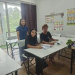 A teacher and two students in the classroom