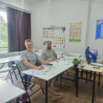 A teacher with two students in a Thai language class