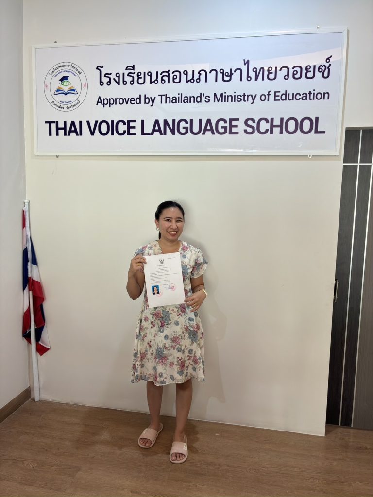 Kru Aoy holding the Thai Voice Language School license